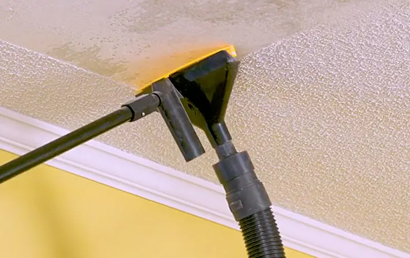 Popeeze: Popcorn ceiling scraper tool with vacuum attachment