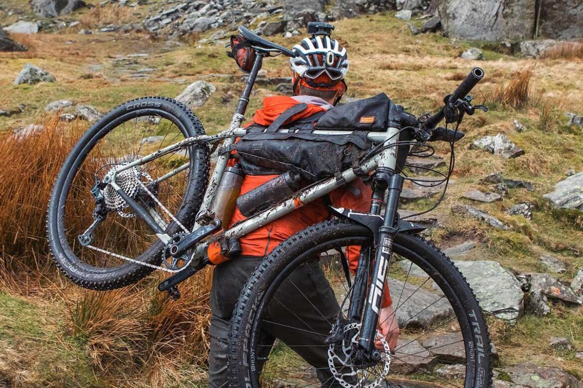 Carry a bike on your back with Hike A Bike Harness for seamless bikepacking