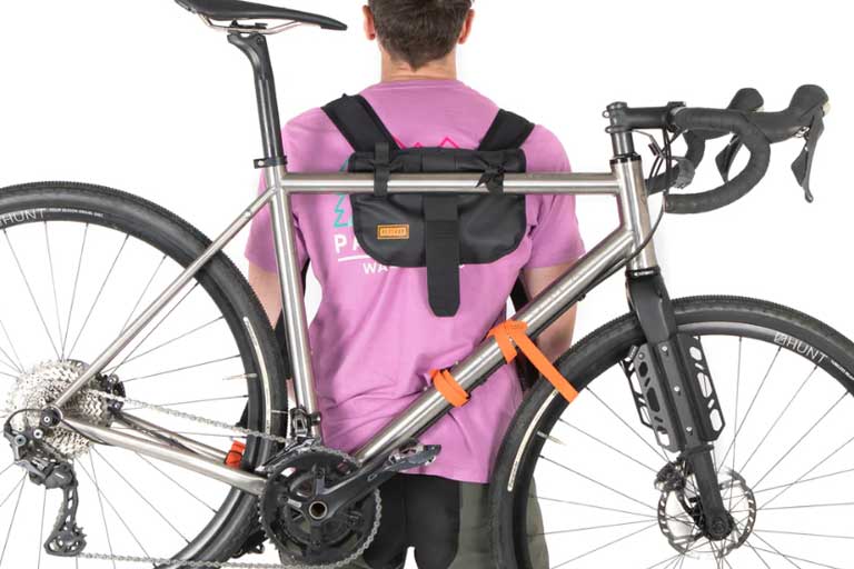 Carry a bike on your back with Hike A Bike Harness for seamless bikepacking