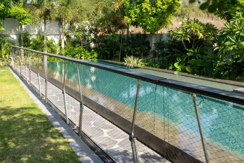 Flush-mounted pool fence hidden beneath the ground.